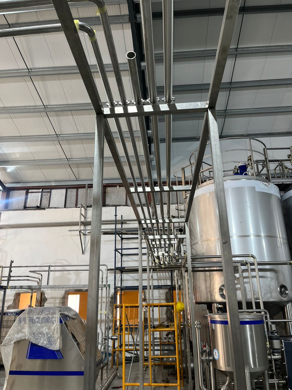 Stainless steel process plant with tanks and pipe runs
