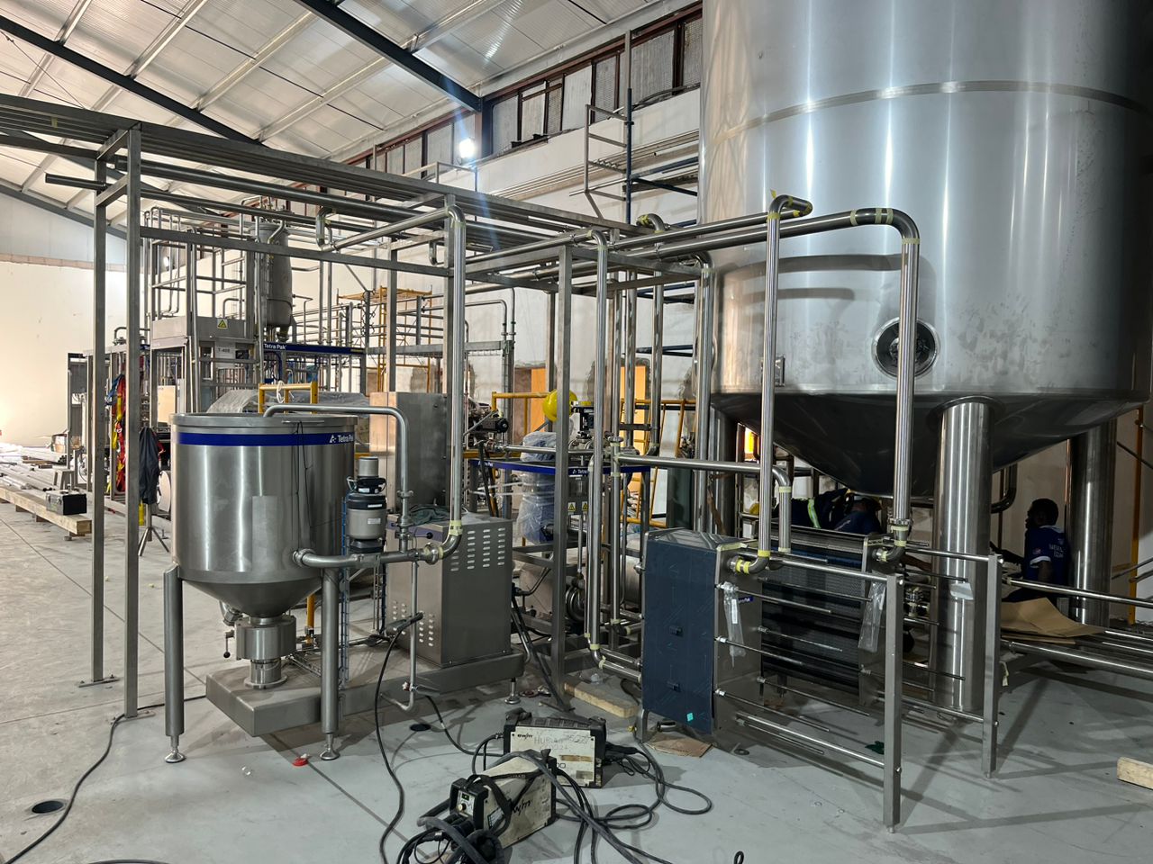 Stainless steel process plant with tanks and integrated pipe runs
