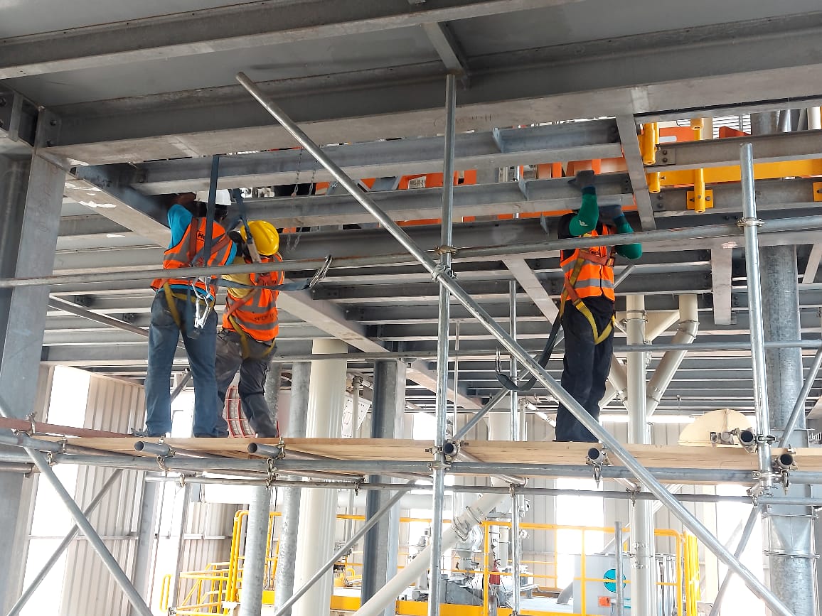 Industrial technicians executing structural maintenance work